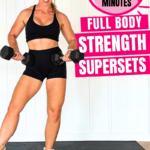 Woman over 40 holding a pair of dumbbells in a home gym for a 20 minute full body strength workout, with the words full body strength supersets