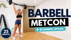 Penny pressing a barbell overhead in her garage gym for a 25 minute barbell Tabata metabolic workout with dumbbell options