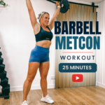 Woman pressing a barbell overhead in a home garage gym, from a 25 minute barbell Tabata metabolic workout for women over 40