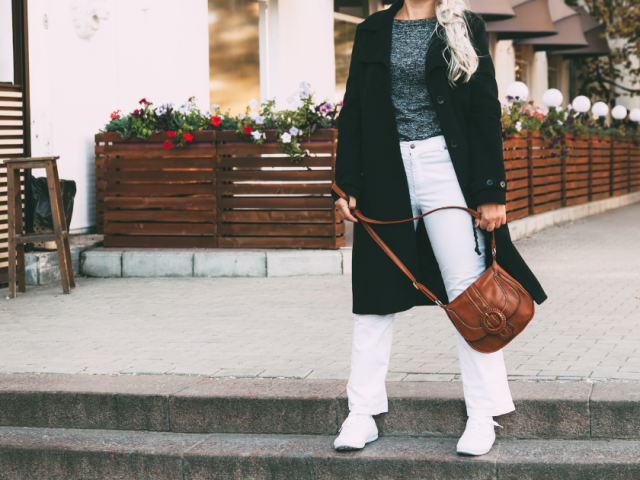 Woman standing in the street wearing a stylish outfit, representing personal style, identity shift, and intentional living after 40.