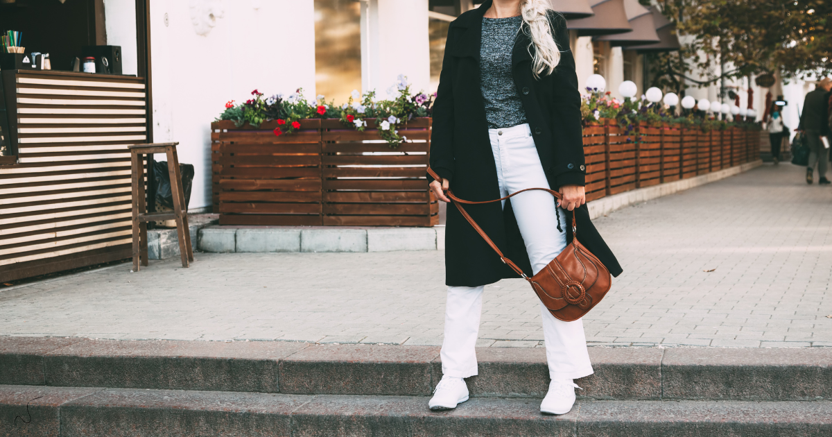 Woman standing in the street wearing a stylish outfit, representing personal style, identity shift, and intentional living after 40.