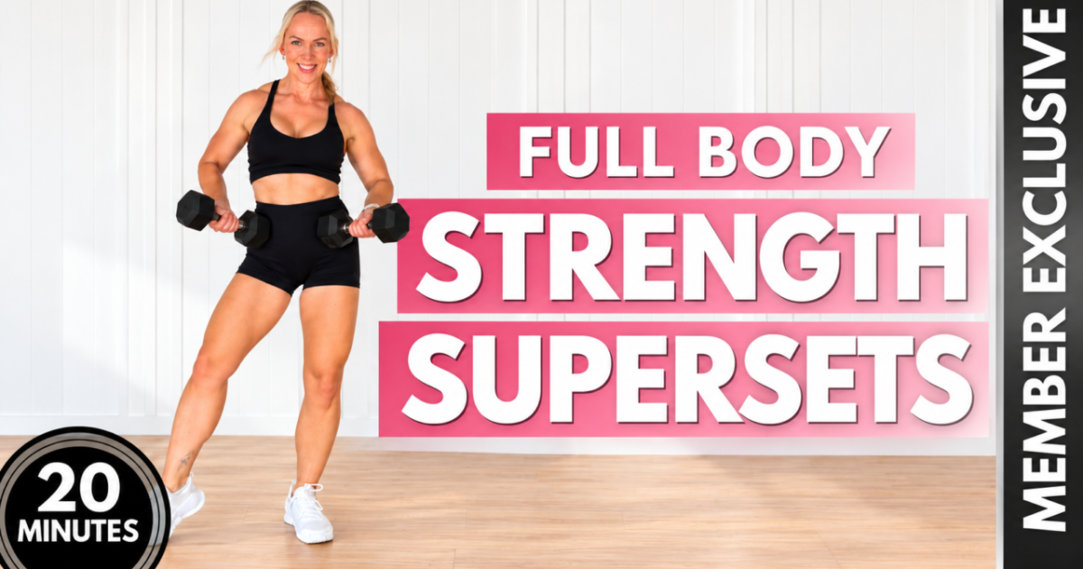 Woman over 40 stepping to the side with a dumbbell in each hand in a home gym, with the words 20 minutes full body strength supersets member exclusive, for a full body strength workout